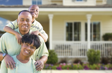 Family standing in front of their home